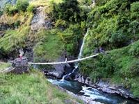 Crossing the river bridge to get Muri Village