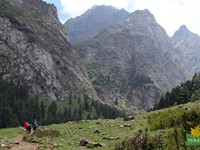 Flat meadow in this side and a steep ridge on the other side